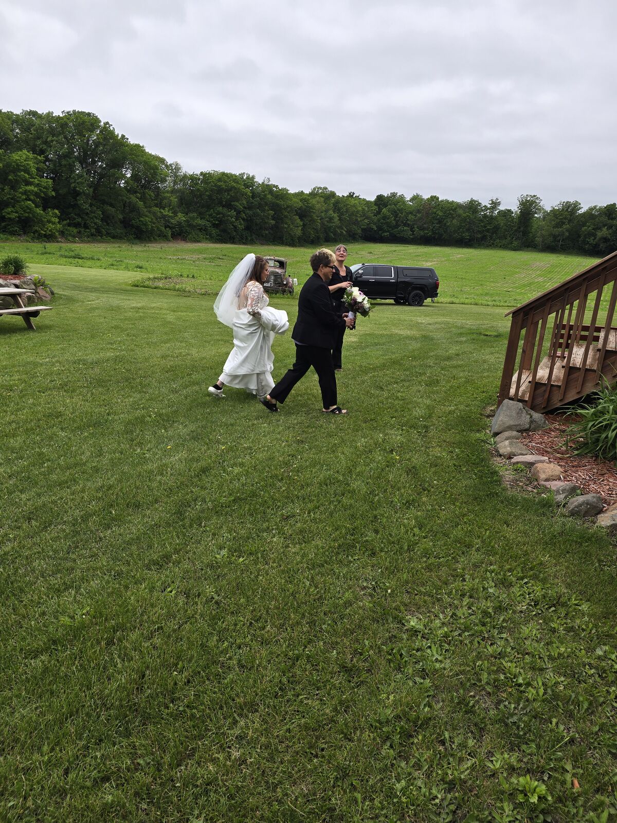 Bride and groom walking through the field