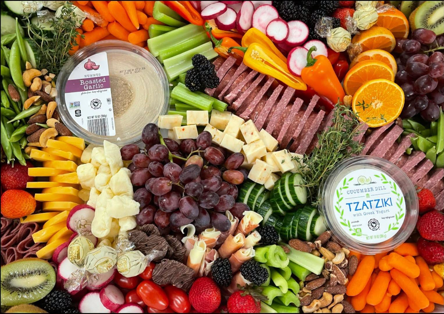 Snack tray with cheese, summer sausage, veggies, fruit, and dips