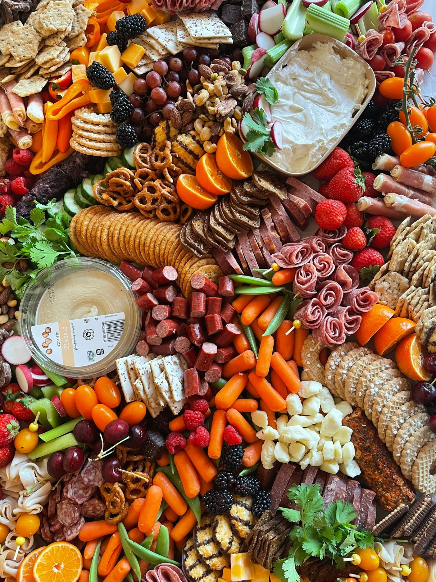 Overhead view of a fully loaded snack board with no empty gaps